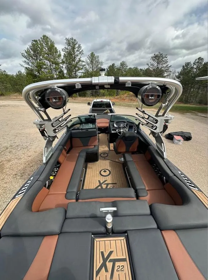 Slide: The Image of 2021 MasterCraft XT22 boat interior with premium seating and advanced sound system. - 3