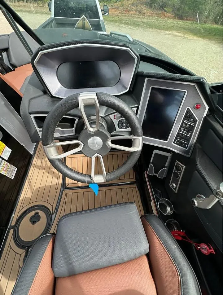 Slide: The Image of 2021 MasterCraft XT22 boat cockpit with modern steering and control panel. - 4