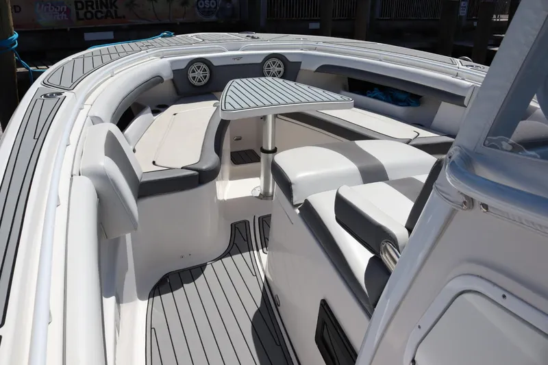 Slide: The Image of 2019 Tidewater 320 CC Adventure boat interior with seating and table. - 8