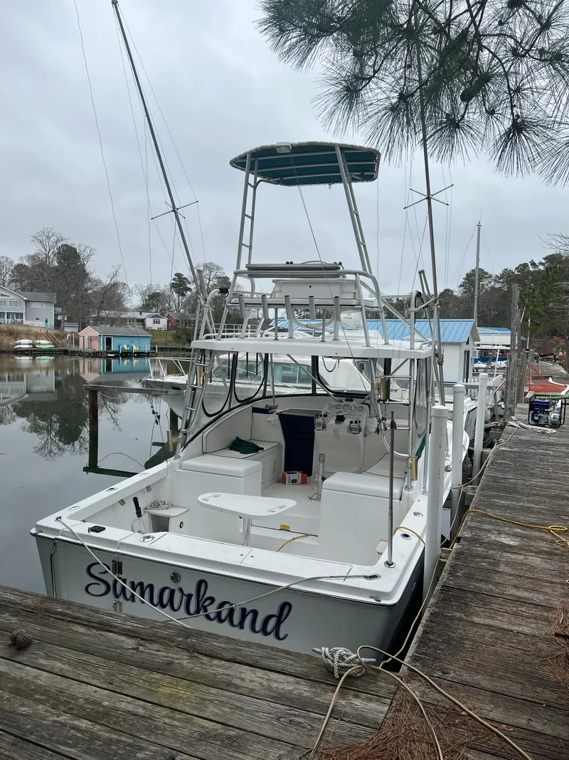 The Image of 1995 Luhrs 290 boat docked, featuring a tower and open deck, named "Samarkand." - 0