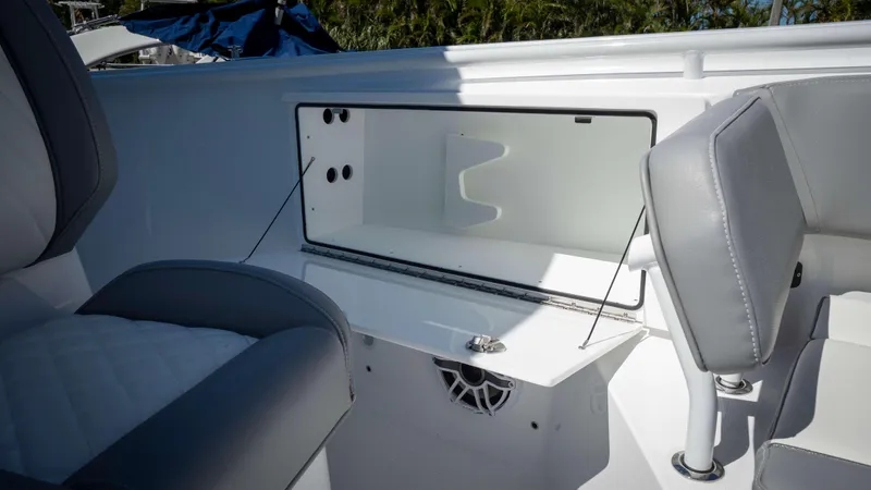 Slide: The Image of 2025 Everglades 335 CC boat interior with open storage compartment and seating. - 11