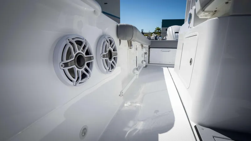 Slide: The Image of 2025 Everglades 335 CC boat interior with speakers and seating. - 15