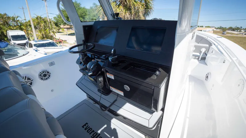 Slide: The Image of 2025 Everglades 335 CC boat cockpit with modern controls and dual screens. - 17