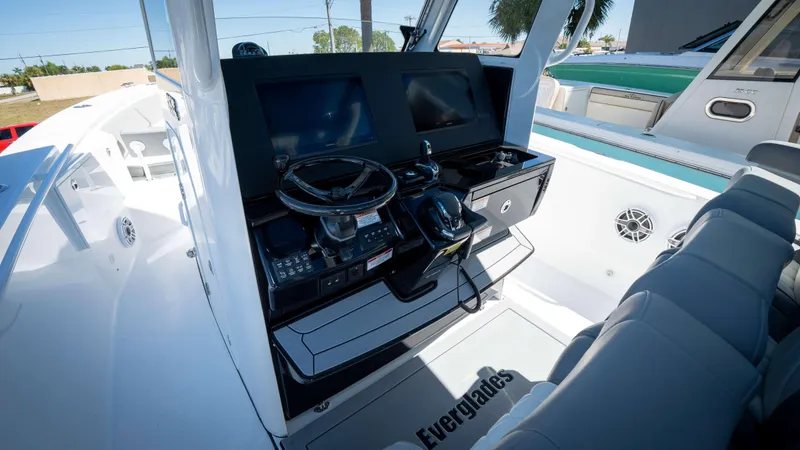Slide: The Image of 2025 Everglades 335 CC boat cockpit with modern steering and navigation system. - 18