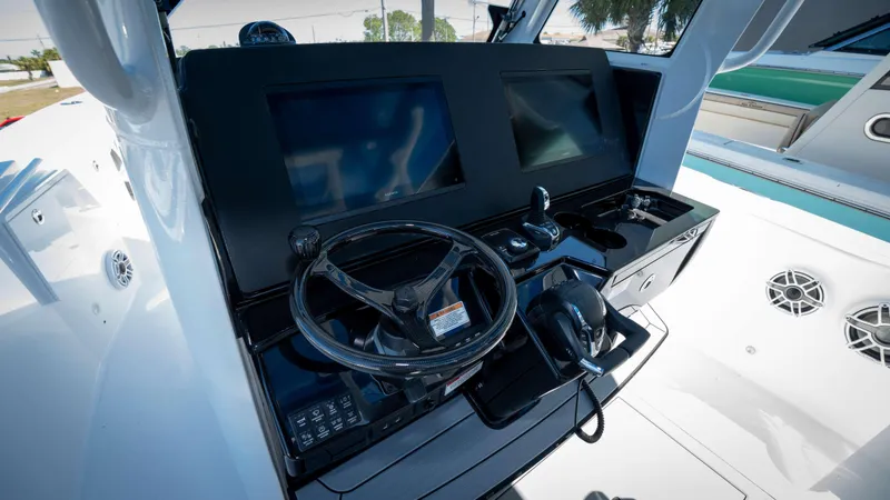 Slide: The Image of Helm of 2025 Everglades 335 CC boat with modern controls and dual screens. - 22