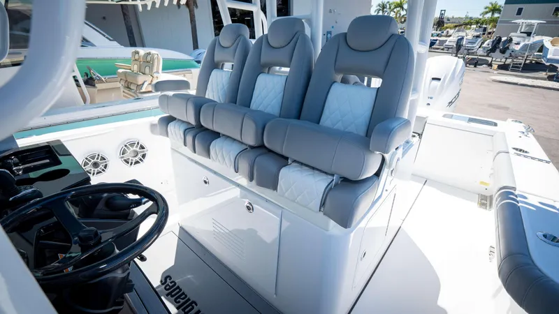 Slide: The Image of 2025 Everglades 335 CC boat interior with luxurious seating and modern steering console. - 25
