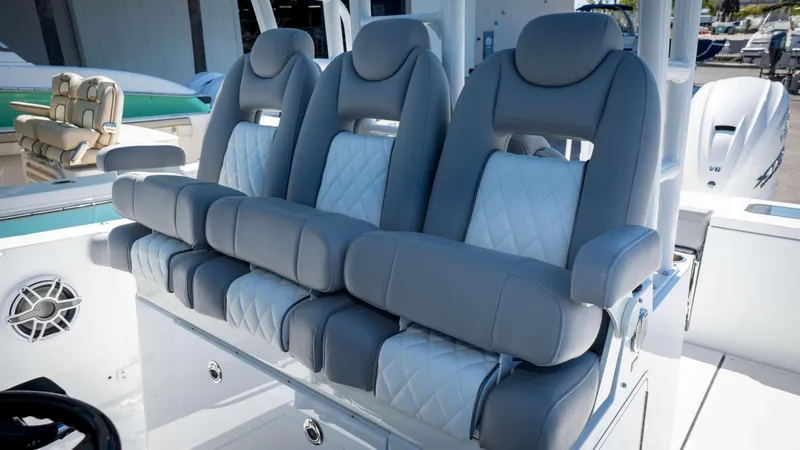 Slide: The Image of Luxurious seating on 2025 Everglades 335 CC boat, featuring plush gray and white upholstery. - 26