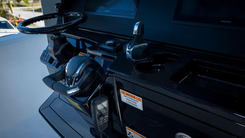 Slide: The Image of Control panel of 2025 Everglades 335 CC boat with steering wheel and controls. - 29