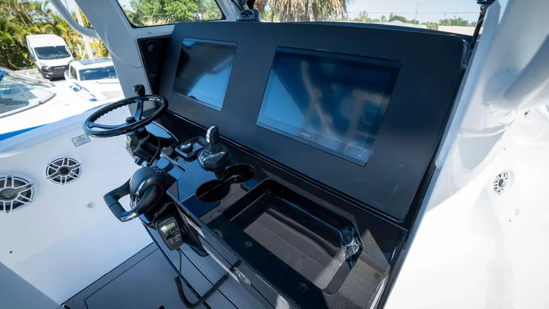Slide: The Image of Helm of 2025 Everglades 335 CC boat with dual screens and steering wheel. - 30