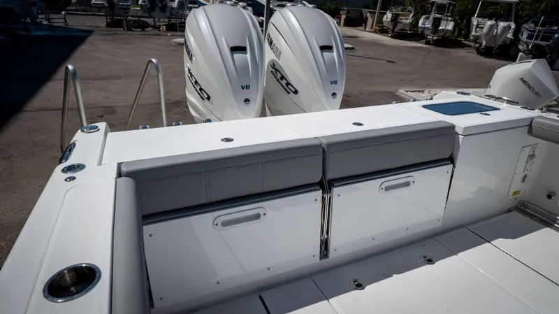 Slide: The Image of 2025 Everglades 335 CC boat with twin Yamaha V8 engines, featuring a spacious deck. - 38