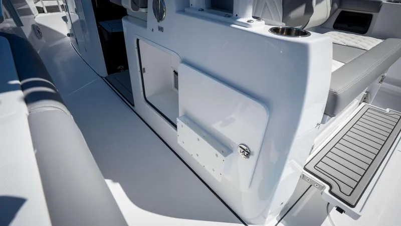 Slide: The Image of 2025 Everglades 335 CC boat interior, featuring sleek seating and storage compartments. - 41