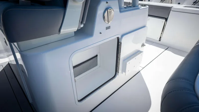 Slide: The Image of 2025 Everglades 335 CC boat interior, featuring sleek storage compartment and seating. - 43