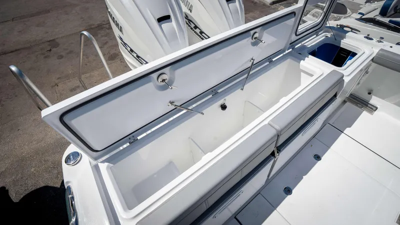 Slide: The Image of 2025 Everglades 335 CC boat with open storage compartment and sleek design. - 46