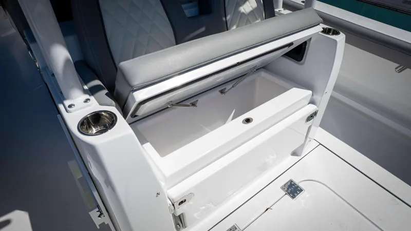 Slide: The Image of 2025 Everglades 335 CC boat seat with storage compartment and cup holders. - 48