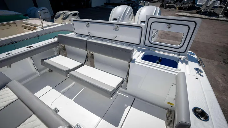 Slide: The Image of 2025 Everglades 335 CC boat interior with seating and storage compartments. - 49