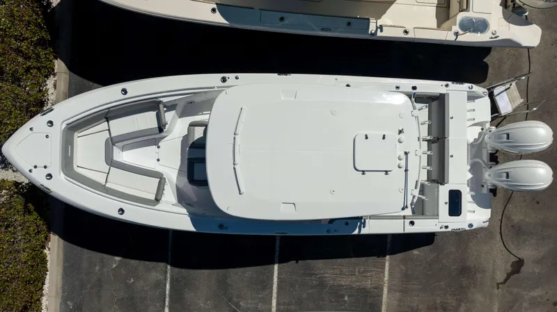 Slide: The Image of Overhead view of 2025 Everglades 335 CC boat with dual engines, docked. - 6