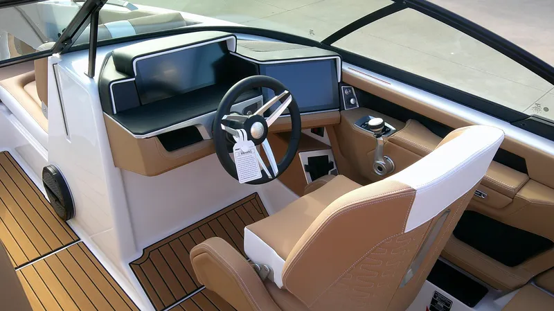Slide: The Image of 2025 MasterCraft X24 boat interior with modern dashboard and tan seating. - 6