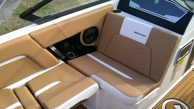 Slide: The Image of 2025 MasterCraft X24 boat interior with tan and white seating, showcasing luxury design. - 8