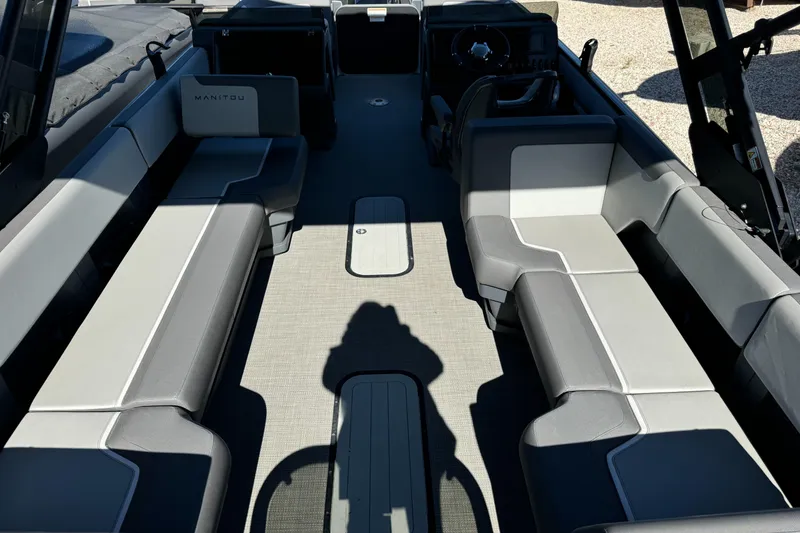 Slide: The Image of 2024 Manitou 22' Cruise Max Switchback interior with spacious seating and modern design. - 1