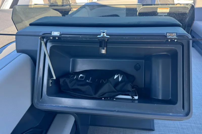 Slide: The Image of 2024 Manitou 22' Cruise Max Switchback storage compartment with cover inside. - 10