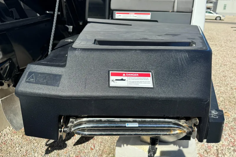 Slide: The Image of 2024 Manitou 22' Cruise Max Switchback boat component with warning label, close-up view. - 19