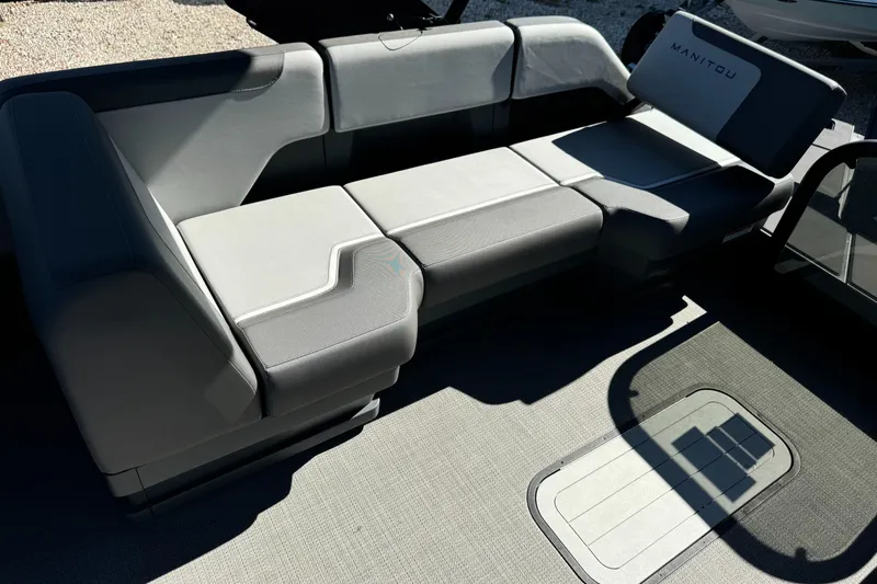 Slide: The Image of 2024 Manitou 22' Cruise Max Switchback boat seating, featuring modern gray upholstery. - 3