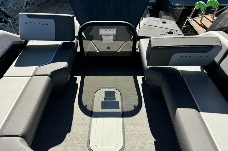 Slide: The Image of 2024 Manitou 22' Cruise Max Switchback interior with gray seating and flooring. - 4