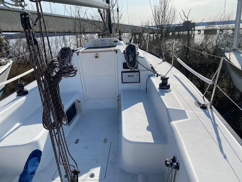 Slide: The Image of Tartan 101 sailboat cockpit, 2013 model, with ropes and winches, docked near water. - 11