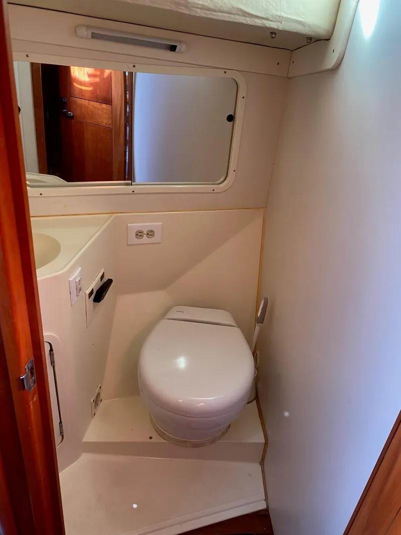 Slide: The Image of Compact bathroom in 2013 Tartan 101 sailboat with toilet and mirror. - 15