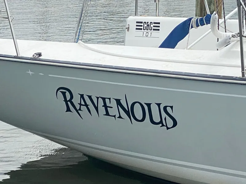 Slide: The Image of Sailboat named "Ravenous," Tartan 101 model, 2013, docked on calm water. - 4