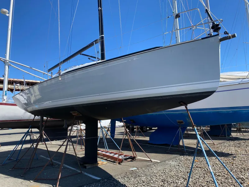 Slide: The Image of Sailboat on stands, Tartan 101 model, 2013, in a marina under clear blue sky. - 9