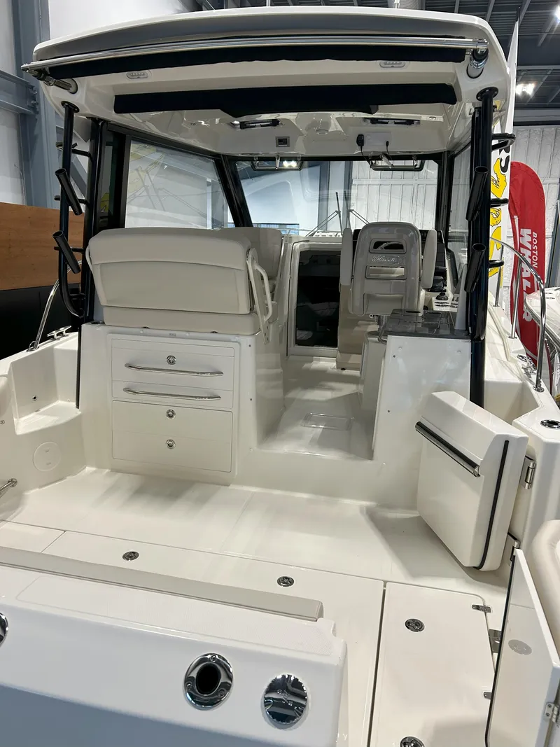 Slide: The Image of 2025 Boston Whaler 325 Conquest boat interior, showcasing seating and storage features. - 1