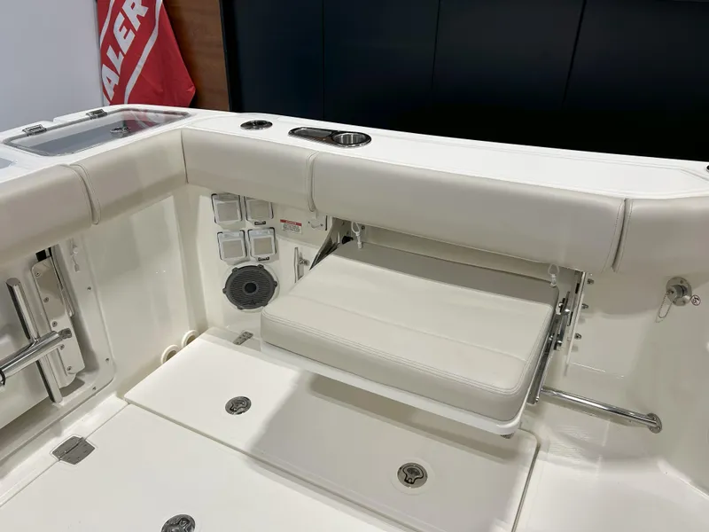 Slide: The Image of 2025 Boston Whaler 325 Conquest boat interior with foldable seat and storage compartments. - 13