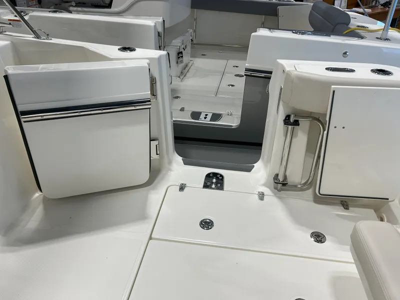 Slide: The Image of 2025 Boston Whaler 325 Conquest boat interior with open compartments and seating area. - 16