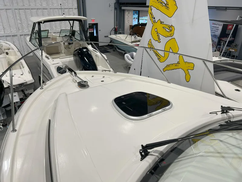 Slide: The Image of 2025 Boston Whaler 325 Conquest boat displayed in a showroom, showcasing sleek design and features. - 18