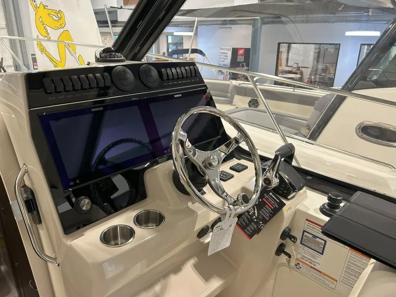 Slide: The Image of 2025 Boston Whaler 325 Conquest helm with modern controls and sleek design. - 22
