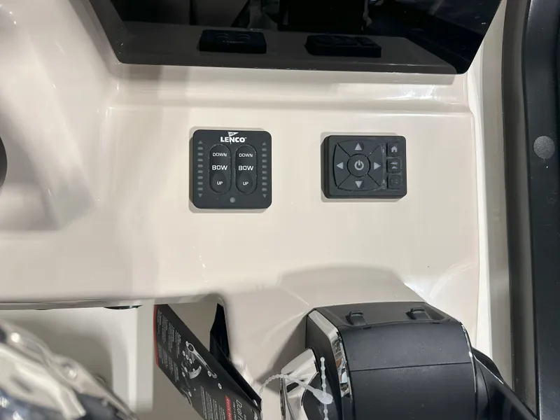 Slide: The Image of Control panel of 2025 Boston Whaler 325 Conquest boat, featuring Lenco trim tab controls. - 25