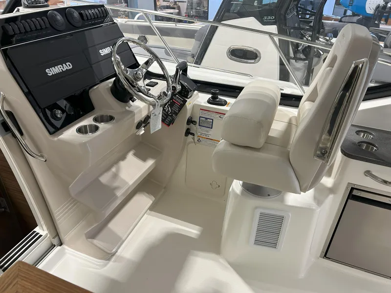 Slide: The Image of 2025 Boston Whaler 325 Conquest helm with Simrad electronics and comfortable seating. - 29
