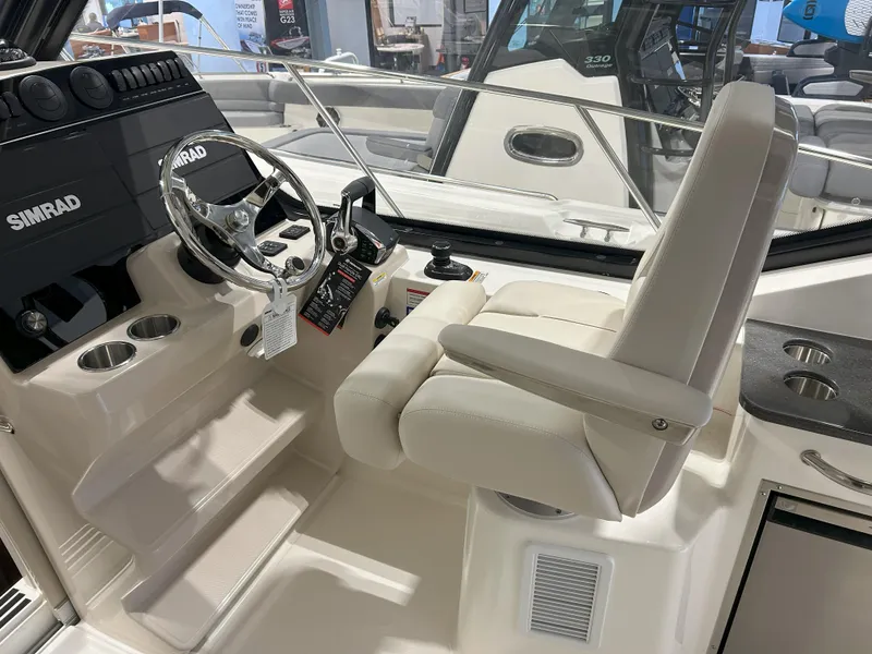 Slide: The Image of 2025 Boston Whaler 325 Conquest helm with Simrad electronics and comfortable seating. - 30
