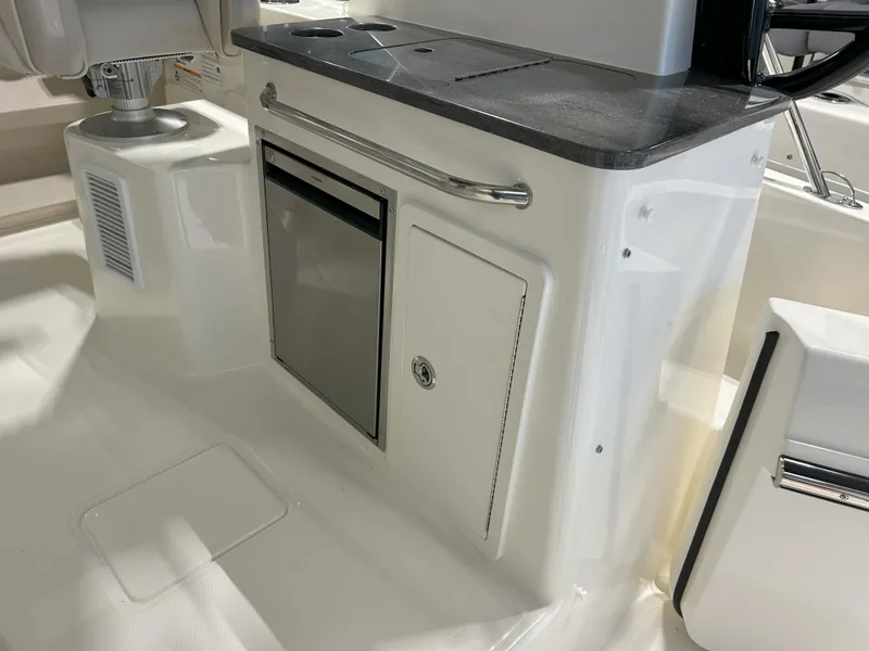 Slide: The Image of 2025 Boston Whaler 325 Conquest interior with sleek cabinetry and modern design. - 36