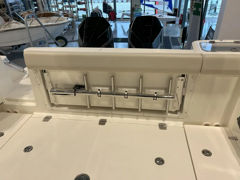 Slide: The Image of 2025 Boston Whaler 325 Conquest boat interior with rod holders and seating. - 43