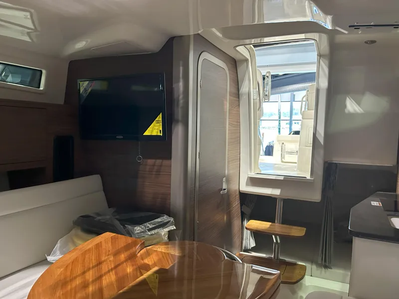Slide: The Image of Interior of 2025 Boston Whaler 325 Conquest, featuring modern seating and entertainment area. - 5