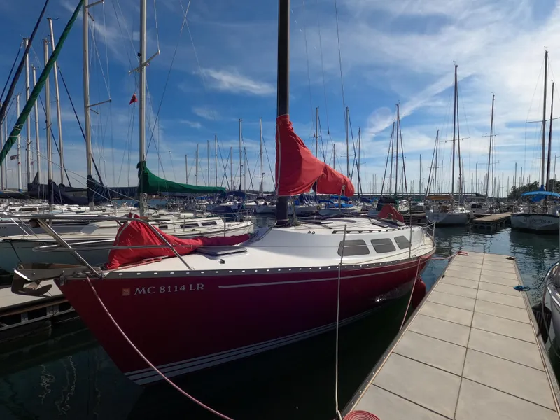 The Image of Red Freedom 32 sailboat docked in marina, clear sky, 1984 model. - 0