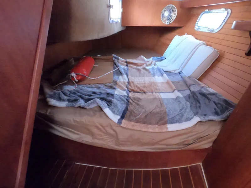 Slide: The Image of Cozy cabin interior of 1984 Freedom 32 sailboat with bed and portholes. - 11