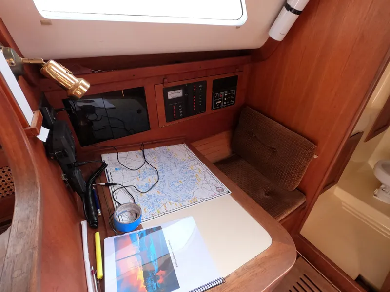 Slide: The Image of Navigation station in a 1984 Freedom 32 sailboat with map, radio, and controls. - 21