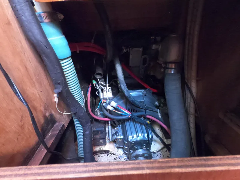 Slide: The Image of Engine compartment of a 1984 Freedom 32 sailboat, showing hoses and wiring. - 22