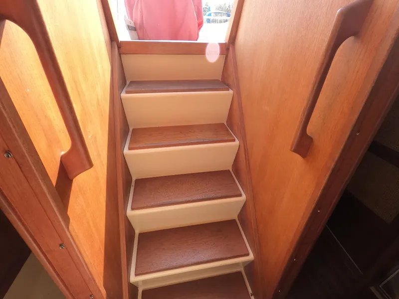 Slide: The Image of Wooden interior stairs on a 1984 Freedom 32 boat. - 23