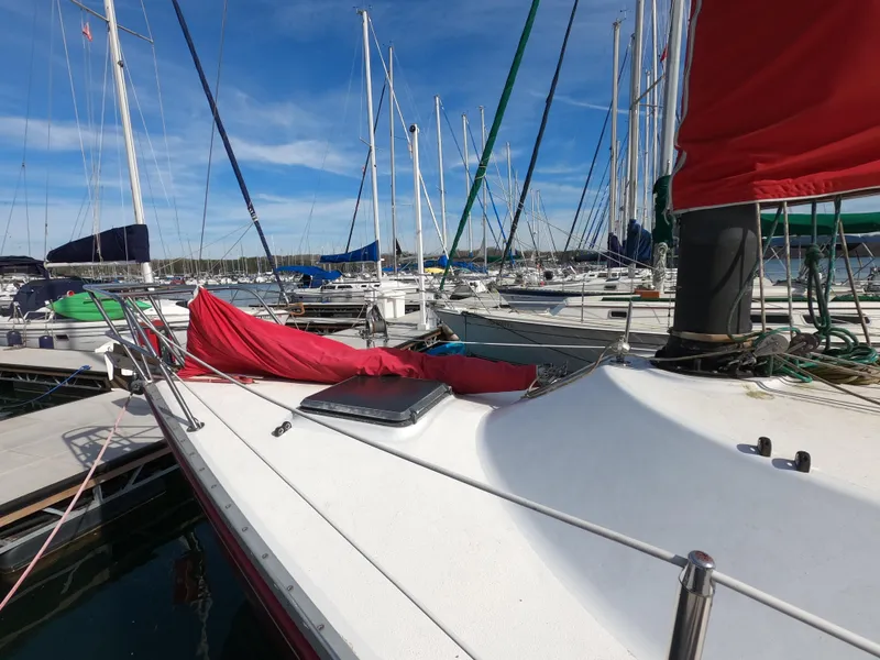 Slide: The Image of Sailboat docked in marina, Freedom 32 model, 1984, with red sail cover. - 28