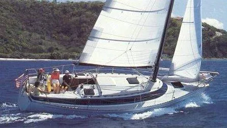 Slide: The Image of Sailboat Freedom 32, 1984 model, cruising on blue ocean near lush coastline. - 32