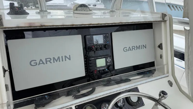 Slide: The Image of Console of 2003 SeaVee 34B boat with dual Garmin displays and navigation equipment. - 11